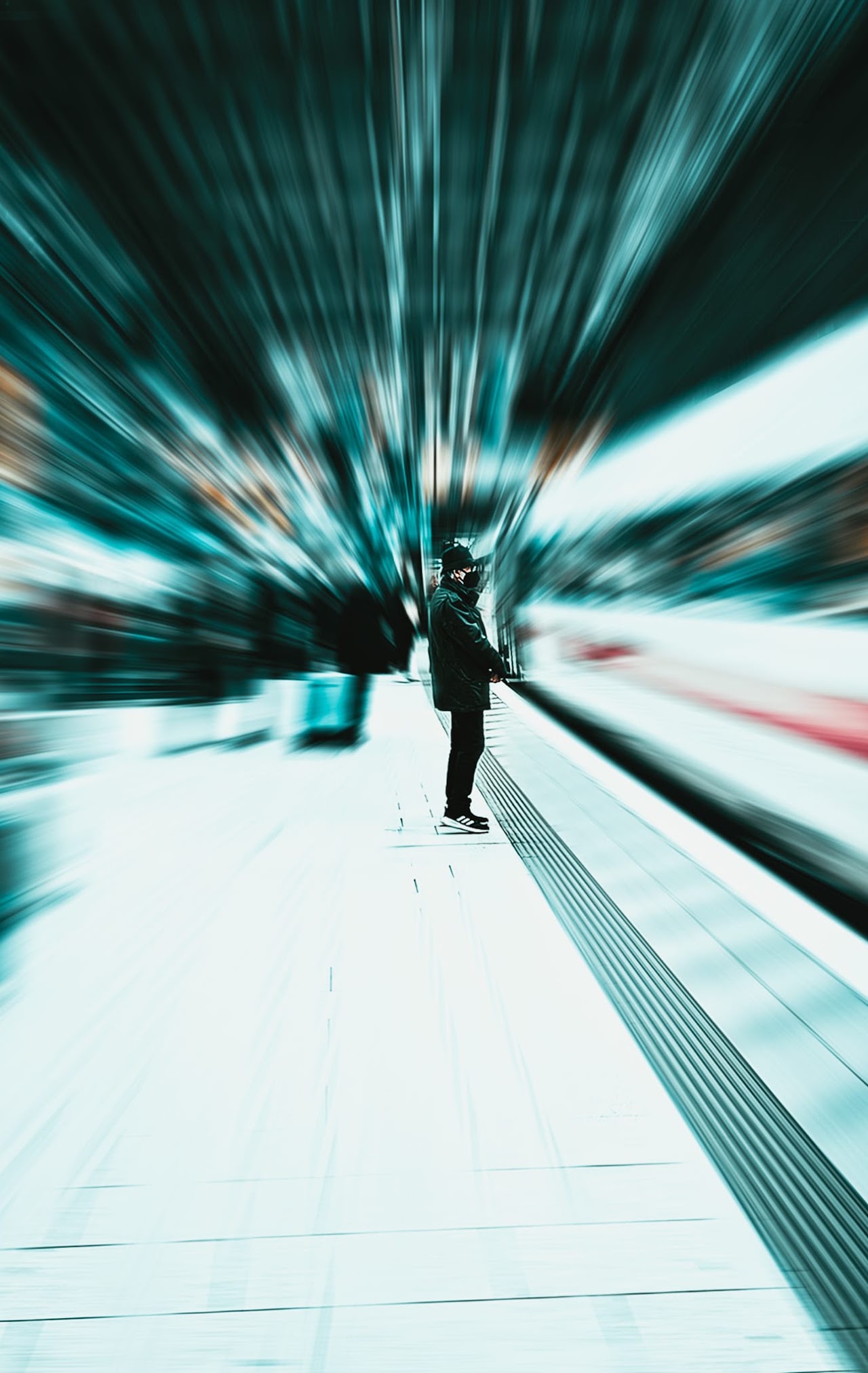 A person standing on a platform with motion blur around them.
